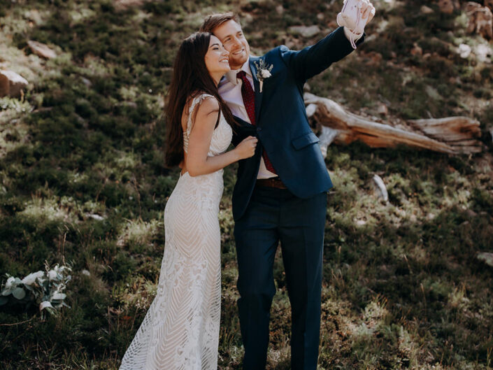bride and groom taking polaroid selfie
